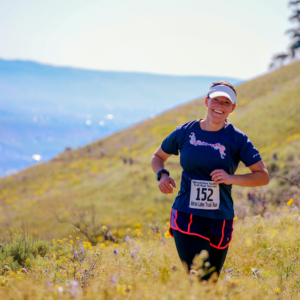 Woman enjoying a trail marathon in the vibrant hills of Wenatchee, Washington.